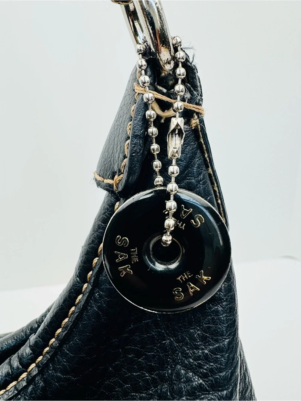 The Sak Baggett hobo. Pebbled leather. Silver-tone hardware. Slouchy Y2K style